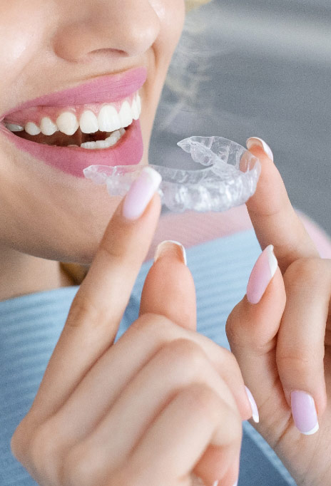 woman-putting-in-clear-aligners